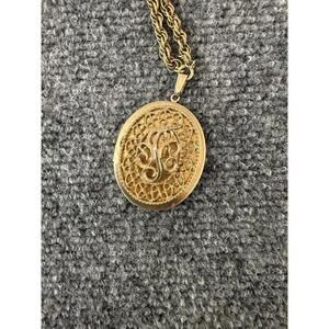 Vintage Signed Sarah Coventry large locket/pendant /w scroll work on gold chain.